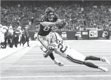  ?? Michael Wyke/Associated Press ?? ■ Houston Texans tight end Ryan Griffin (84) reaches for the goal line after catching a pass as Indianapol­is Colts cornerback Kenny Moore (23) defends Sunday in Houston. Griffin was ruled down just short of the end zone.