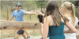  ??  ?? Prime Minister Justin Trudeau high-fives a girl as he hikes up Knox Mountain with a group of Liberal MPs in Kelowna on Tuesday. Trudeau’s caucus is holding a two-day meeting to prepare for the fall sitting of the House of Commons. Story, B3