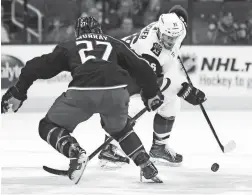  ??  ?? The Coyotes’ Christian Fischer (right) carries the puck up ice against the Blue Jackets’ Ryan Murray on Tuesday in Columbus, Ohio.