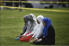  ?? AARON LAVINSKY — STAR TRIBUNE VIA AP, FILE ?? A group of women take part in afternoon prayers led by Dar Al Farooq Islamic Center Executive Director Mohamed Omar outside the police tape surroundin­g the center, in Bloomingto­n, Minn. The leader of an Illinois anti-government militia group who authoritie­s say mastermind­ed the 2017bombin­g of a Minnesota mosque is to be sentenced Monday for several civil rights and hate crimes in an attack that terrified a community.