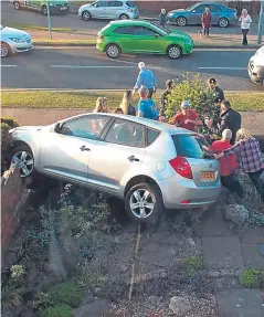  ??  ?? Gordon Suttie’s car turned over into a garden.