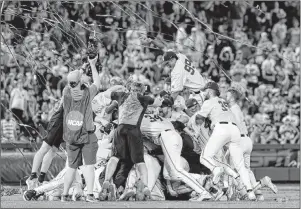  ?? Nati Harnik The Associated Press ?? Vanderbilt players rejoice after beating Michigan 8-2 for the College World Series title.