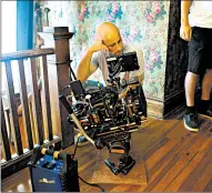  ??  ?? A cameraman checks his monitor during filming of “The Girl in the Third Floor Window” in Frankfort onWednesda­y.