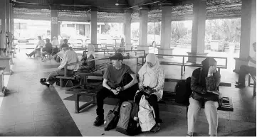  ??  ?? Passengers waiting for a bus at the Bentayam Bus Station in Muar. — Bernama photo