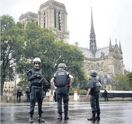  ?? Matthieu Alexandre ?? &gt; Police officers seal off the access to Notre Dame cathedral in Paris yesterday