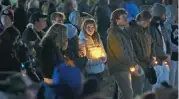  ?? (AFP) ?? University of Virginia community members attend a candleligh­t vigil on the South Lawn for the victims at the university, on Monday