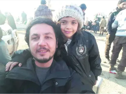  ?? AFP ?? Aid worker Burak Karacaoglu took a selfie with Bana Al Abed after she arrived safely in Idlib province from Aleppo.
