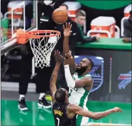  ?? Omar Rawlings / Getty Images ?? The Celtics’ Jaylen Brown drives to the basket over the Nets’ Kevin Durant during the second quarter on Friday in Boston.