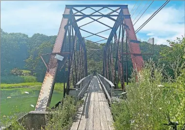  ?? LINDSAY BOYLE/THE DAY ?? Above, a 1907 bridge that used to carry trolleys from New Haven to Branford, as seen in Branford on July 17. Below, some of the Thimble Islands off the Trolley Trail in Branford on July 17. Visit www.theday.com for a video.