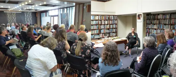  ??  ?? Delegates during one hui session at the Dunedin City Library
Elizabeth Pulford and Sophie Siers talking about picture books at the
Dunedin Athenaeum Library