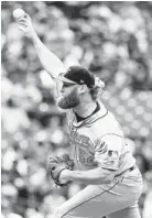  ?? ABBIE PARR/GETTY ?? Andrew Cashner pitches six strong innings against the Mariners to improve to 7-3.