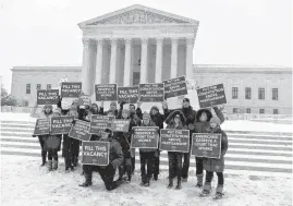  ?? [AP PHOTO] ?? A group with “People for the American Way” from Washington, gather Monday with signs in front of the U.S. Supreme Court in Washington. They are calling for Congress to give fair considerat­ion to any nomination put forth by President Barack Obama to...