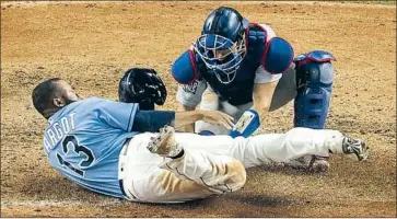  ?? Photograph­s by Robert Gauthier Los Angeles Times ?? THE DODGERS’ Austin Barnes tags out the Rays’ Manuel Margot on an attempted steal of home in Game 5 of the World Series. A defensive specialist, Barnes started four of the six World Series games at catcher.