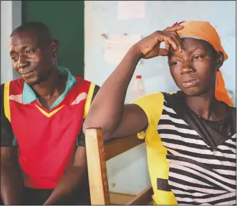  ??  ?? Danssanin Lanizou, 30, (right) sits with her husband, Yakouaran Boue, as their one-month old daughter, Haboue Solange Boue, receives medical treatment for severe malnutriti­on at the feeding center of the main hospital in the town of Hounde, Tuy Province, in southweste­rn Burkina Faso on June 11. Boue used to sell onions to buy seeds and fertilizer, but then the markets closed. “I’m worried that this year we won’t have enough food to feed her,” he said. “I’m afraid she’s going to die.”
(AP/Sam Mednick)