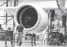  ?? CHRISTINNE MUSCHI/BLOOMBERG FILES ?? Bombardier staff work on the CS300 airplane in Mirabel, Que., last Friday. EgyptAir is buying a dozen of the aircraft and purchase rights for 12 more planes.