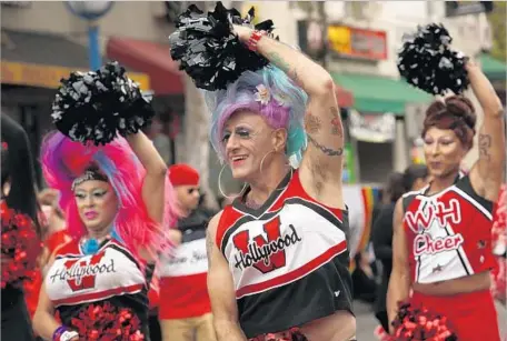  ?? Photograph­s by Genaro Molina Los Angeles Times ?? IDA STAPEDHER, left, Sal Ianniello and Kari Okee, all of West Hollywood Cheerleade­rs, march in L.A.’s pride parade June 12.