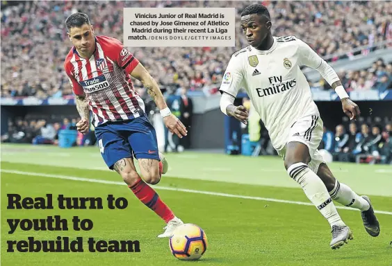  ?? /DENIS DOYLE/GETTY IMAGES ?? Vinicius Junior of Real Madrid is chased by Jose Gimenez of Atletico Madrid during their recent La Liga match.