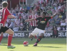  ?? TIM IRELAND /AP PHOTO ?? Man U’s Anthony Martial scores against Southampto­n in Southampto­n, England, on Sunday. United won 3-2.