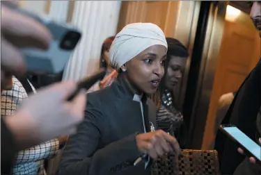  ?? JOSE LUIS MAGANA — THE ASSOCIATED PRESS ?? Rep. Ilhan Omar, D-minn., talks to reporters as she leaves the House chamber at the Capitol in Washington on Thursday. House Republican­s have voted to oust Omar from the House Foreign Affairs Committee. The vote in a raucous session on Thursday to remove the Somali-born Muslim lawmaker came after her past comments critical of Israel.