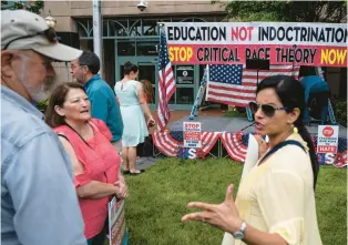  ?? ANDREW CABALLERO-REYNOLDS/GETTY-AFP ?? People talk before a rally Sunday against critical race theory being taught in schools at the Loudoun County Government center in Leesburg.