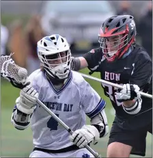  ?? KYLE FRANKO — TRENTONIAN PHOTO ?? Princeton Day’s Alexander Gardner (4) controls the ball as he’s checked by Hun’s Cameron Donovan (32) during a prep boys lacrosse game on Thursday afternoon.