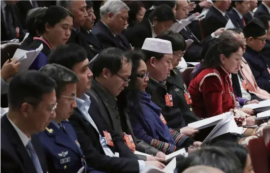  ??  ?? Members of the Chinese People’s Political Consultati­ve Conference National Committee, China’s top political advisory body, observe the opening session of the National People’s Congress, the country’s top legislatur­e, in Beijing on March 5