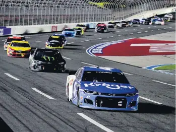  ?? JARED C. TILTON/GETTY IMAGES ?? Ricky Stenhouse Jr. leads a pack of cars Thursday at Charlotte Motor Speedway, where he finished fourth.