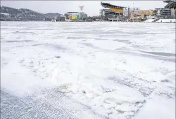  ?? Antonella Crescimben­i/Post-Gazette ?? A frozen Ohio River on Thursday near the Fort Duquesne Bridge.