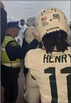  ?? KYLE AUSTIN — MLIVE MEDIA GROUP VIA AP ?? Security and police break up a scuffle between players from Michigan and Michigan State football teams in the Michigan Stadium tunnel after a game on Saturday in Ann Arbor, Mich.