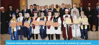  ??  ?? Palestinia­n Ambassador Rami Tahboub and other diplomats pose with the graduates for a group photo. — Photos by Joseph Shagra