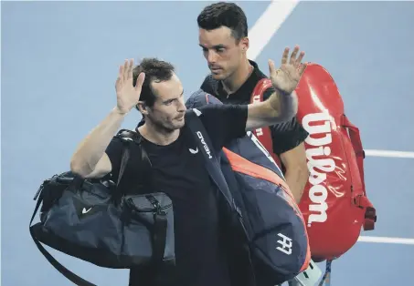  ??  ?? Britain’s Andy Murray waves as he leaves the court following his first round loss to Spain’s Roberto Bautista Agut at the Australian Open.