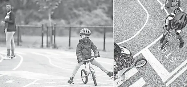  ??  ?? Payton Davis tries to stay in the right lane during a traffic safety lesson at Neval Thomas Elementary School in Washington. • (Right) Pre-K students practise traffic safety in a “traffic garden” on the playground — The Washington Post by Jay Westcott.