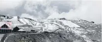  ??  ?? Summer blizzard . . . There was a glimmer of sunshine as snow fell thick and fast on the summits at Cardrona Alpine Resort yesterday.