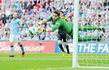  ?? AGENCE FRANCE PRESS ?? Manchester City’s Costel Pantilimon dives to cover a Chelsea shot that goes wide at Wembley Stadium in London on Sunday.