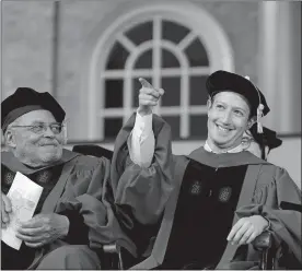  ?? STEVEN SENNE/AP PHOTO ?? Facebook CEO and Harvard dropout Mark Zuckerberg, right, gestures as actor James Earl Jones looks on while seated on stage during Harvard University commenceme­nt exercises on Thursday in Cambridge, Mass. Zuckerberg was presented with an honorary Doctor...