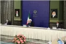  ??  ?? Hassan Rouhani at a meeting in Tehran of a national committee tackling the coronaviru­s outbreak in Iran. Photograph: Anadolu Agency via Getty Images