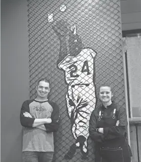  ?? PHOTOS BY DEB CRAM/PORTSMOUTH HERALD ?? John and Martha Edwards are decorating Behind the Plate, their baseball-themed restaurant in Portsmouth, with artwork that includes New York Giants center fielder Willie Mays’ famous catch Game 1 of the World Series on Sept. 29, 1954.