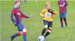  ??  ?? A Maryfield Age 12 (gold and black) player beats his Dundee West Reds opponent to the ball when the sides met at Downfield.