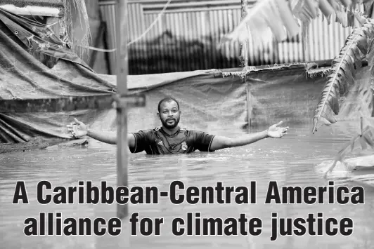  ??  ?? Dwayne McKoy, a resident of Grants Crescent in Hampton Green, Spanish Town, wades through chest-high floodwater­s to the rear of his home, from which he operates a furniture workshop. McKoy said that flooding has been a long-standing issue in the Spanish Town community.