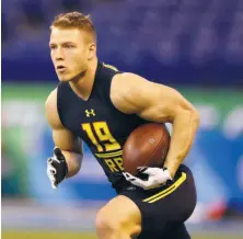  ?? Michael Conroy / Associated Press ?? McCaffrey, running a drill at the combine in Indianapol­is, is projected to be drafted late in the first round.