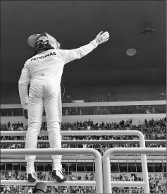  ?? — AFP photo ?? Hamilton waves to fans after taking pole position in qualifying for the Chinese Grand Prix in Shanghai.