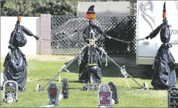  ?? Slideshow @ ?? THREE HALLOWEEN “CREATURES” are gathered around a caldron while chained together in the front yard of a home at 1051 South Angus Way in the Yuma Valley.