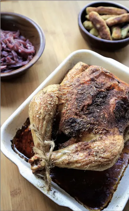  ?? Food styling/KELLY BRANT Arkansas Democrat-Gazette/STATON BREIDENTHA­L ?? Crispy Roast Chicken, or Brathendl, served with Sweet and Sour Red Cabbage and Fried Potato Dumplings is a hearty meal for an Oktoberfes­t celebratio­n.