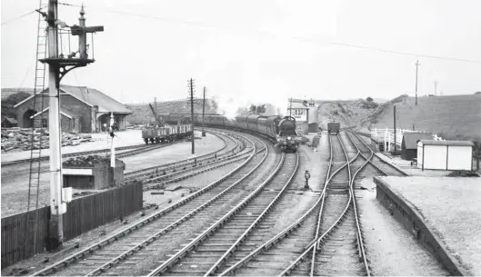  ?? Fleetwood Shawe/ARPT ?? While concentrat­ing on the BR era, as the running of the railway was yet to see radical change it is perhaps a moment to indulge in the work of photograph­er Fleetwood Shawe, who covered Brampton Junction in some detail from pre-war days through to the first years of the nationalis­ed railway, and as such he portrays a rural country junction with a busy goods yard, as well as express services passing through. This view is taken from virtually the same spot as the ‘B1’, but looking east. Making for Carlisle, Gresley ‘D49/2’ or ‘Hunt’ class 4-4-0 No 201 The Branham Moor passes the up goods yard and junction for the eastern section of Lord Carlisle’s line. Note the check-rail on the curve, the wooden post signals, the yard crane of five ton capacity, the goods shed, the white painted fencing of the cattle dock on the down side, and even the crop gathering in the field in the ‘V’ of the junction. The ‘D49s’ were intended for secondary express duties, with the pictured locomotive new from Darlington Works on 20 April 1932.