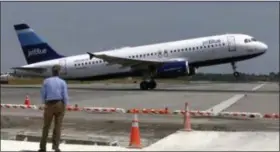  ?? THE ASSOCIATED PRESS ?? In this photo from Wednesday, a man watches a JetBlue airplane take off from John F. Kennedy Internatio­nal Airport in New York.