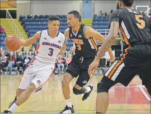  ?? JEREMY FRASER/CAPE BRETON POST ?? Chad Frazier, left, of the Cape Breton Highlander­s works his way around Brandan Kearney, middle, of the Moncton Miracles during National Basketball League of Canada action at Centre 200 on Friday. The Miracles won the game 101-99.