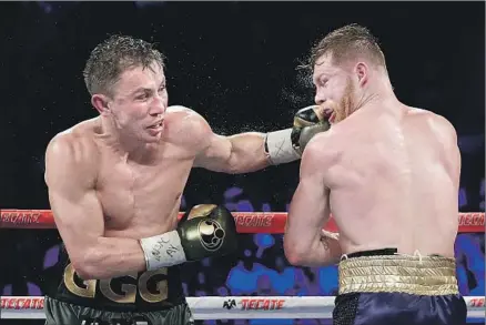  ?? John Locher Associated Press ?? GENNADY GOLOVKIN, left, connects to the face of Canelo Alvarez during their title fight in September, which was ruled a draw.