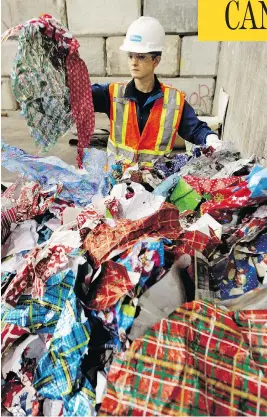  ?? DAVID BLOOM / POSTMEDIA NEWS / QMI AGENCY FILES ?? Alyson Winkelaar of Edmonton Waste Management Services shows some of the metallic wrapping paper that shouldn’t go in blue recycle bins.