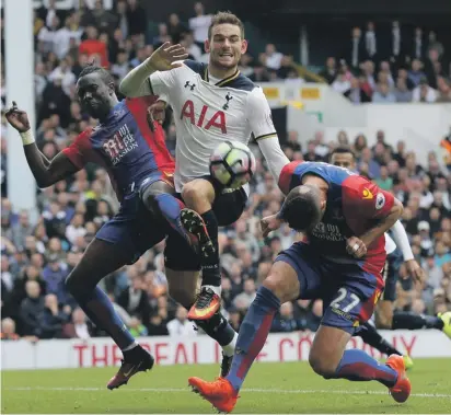  ??  ?? Tottenham's Vincent Janssen, center, competes for the ball with Crystal Palace's Pape N'Diaye Souare, left, and Crystal Palace's Damien Delaney