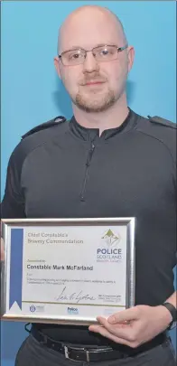  ??  ?? PC Mark McFarland holds his commendati­on.